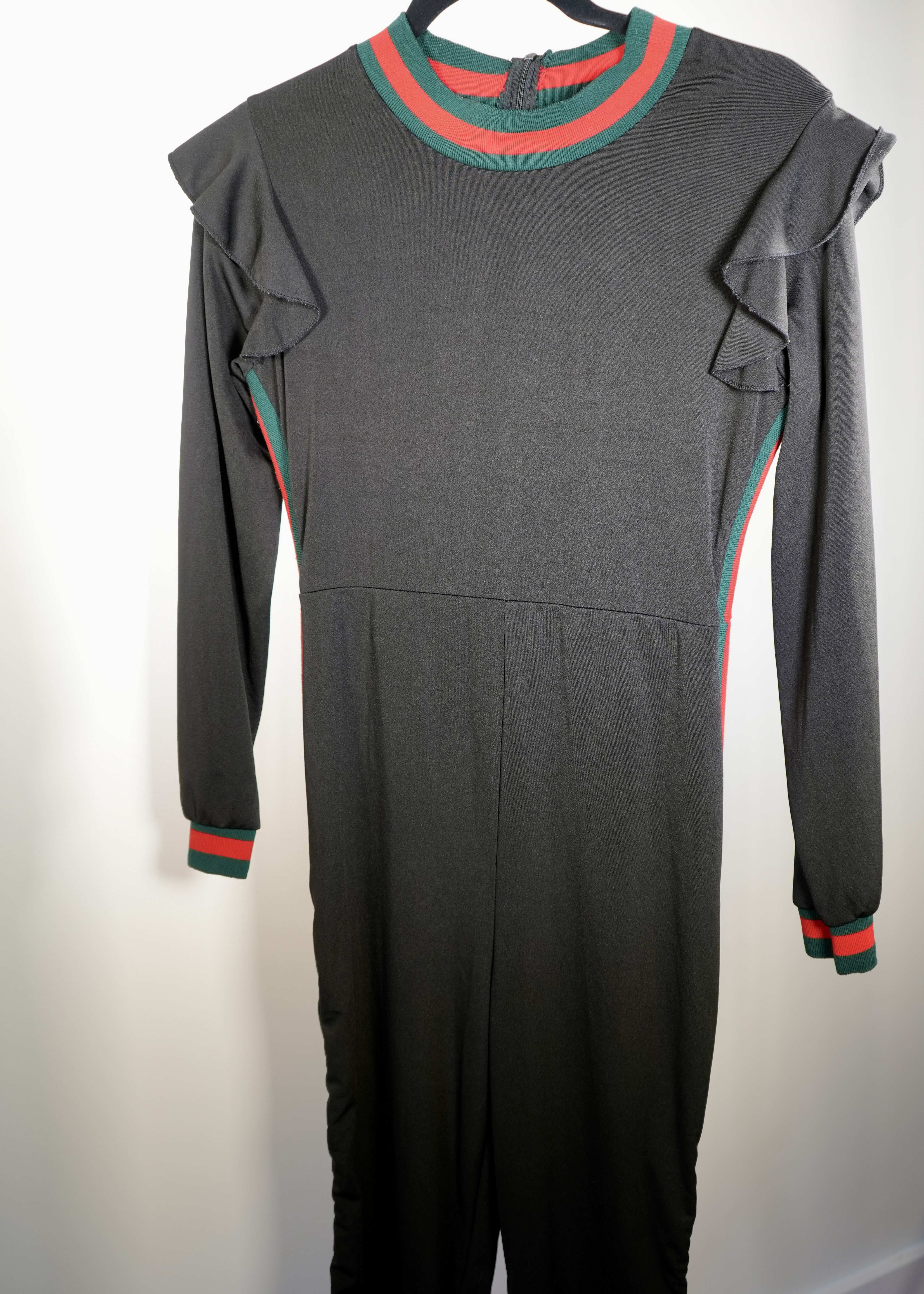 Black ruffle jumpsuit with green and red stripe collar