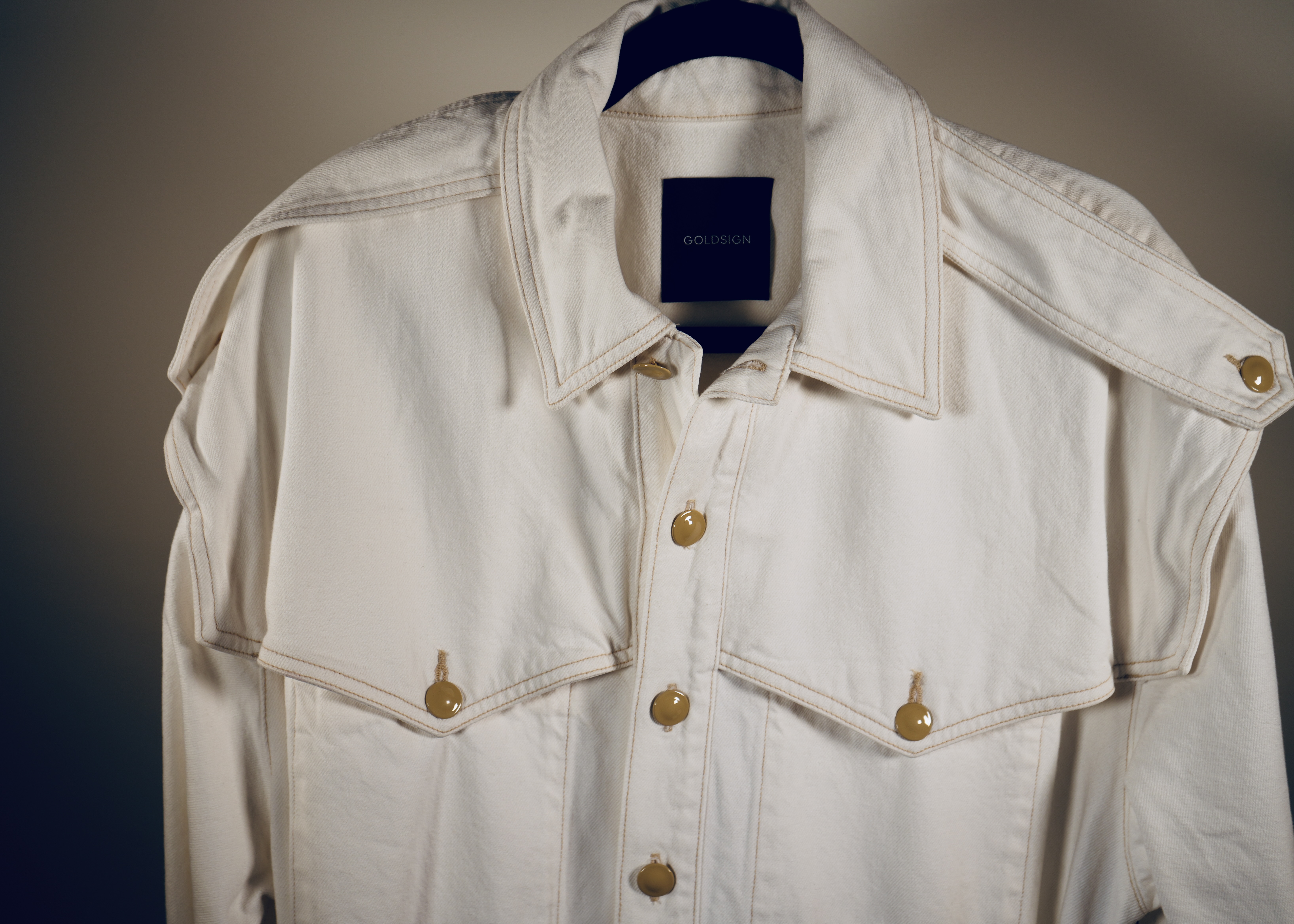 White denim jacket with gold hardware buttons